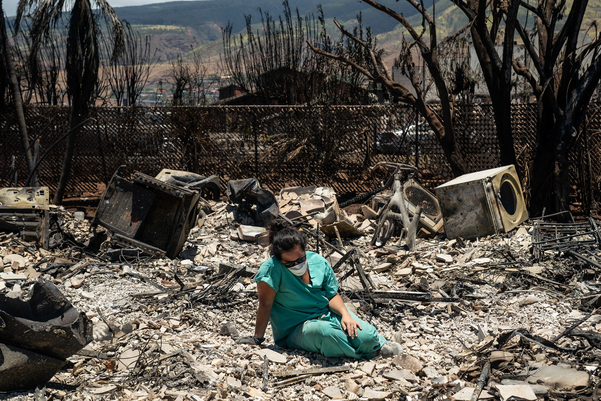 A woman sits where one of her apartments used to be in Lahaina.  NYT's photo