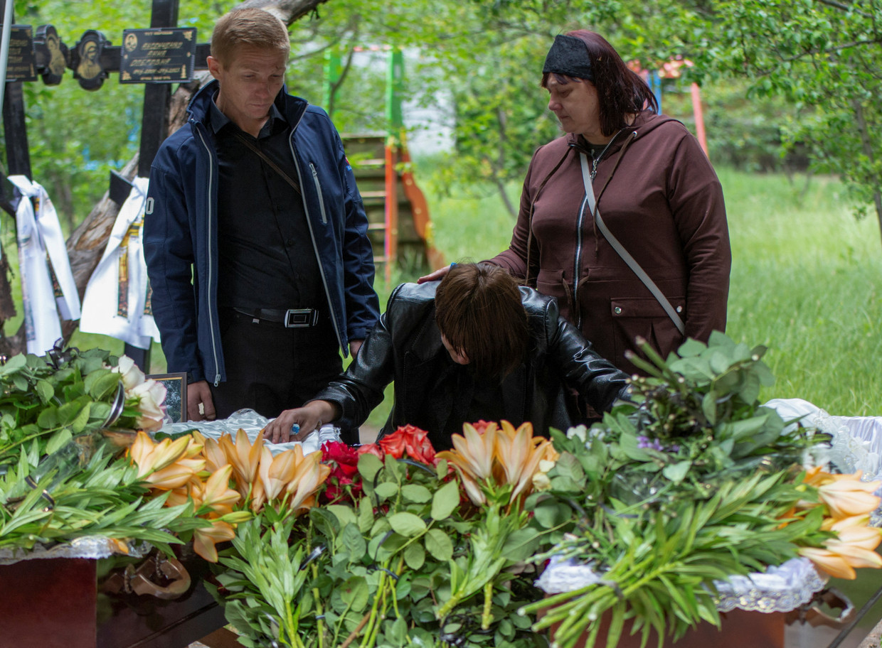The mother of two 14-year-old victims of a Russian missile attack on a restaurant in Kramatorsk weeps at their funeral.  Reuters photo